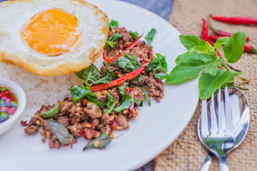 Thai Food Rice topped with egg and stir-fried beef and basil, famous street food in Thailand, fast food, soft focus