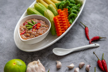 Thai shrimp paste chilli sauce nam prik kapi with fresh vegetables, technology App, hopby Quarantine, home cooking. soft focus.
