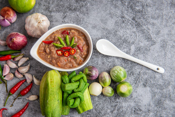 Thai shrimp paste chilli sauce nam prik kapi with fresh vegetables, technology App, hopby Quarantine, home cooking. soft focus.
