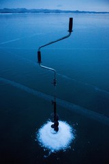 Fototapeta na wymiar Winter fishing on the ice of Lake Baikal.