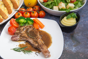 Grilled pork steak with mashed potatoes broccoli and gravy.