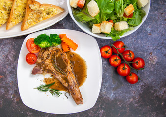 Grilled pork steak with mashed potatoes broccoli and gravy.