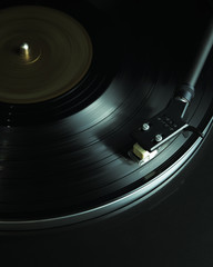 Close up turntable and vinyl disc in motion