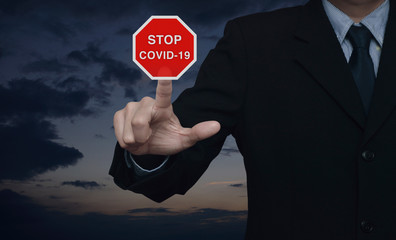 Businessman pressing stop COVID-19 outbreak flat icon over sunset sky, Global epidemic alert, Concept of novel coronavirus outbreak