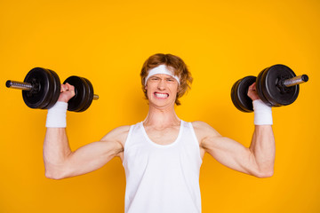 Close-up portrait of his he nice attractive sportive guy sportsman doing work out lifting heavy barbell self developing isolated over bright vivid shine vibrant yellow color background