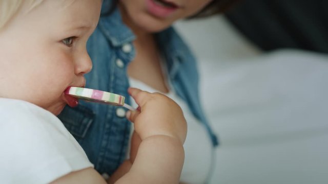 Close up video of toddler licking a lollipop. Shot with RED helium camera in 8K 