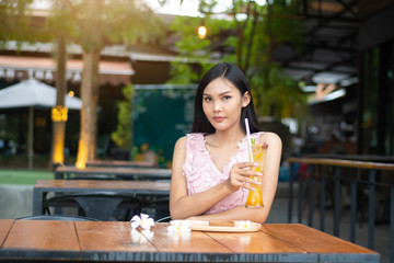 Beautiful woman face portrait with passionfruit  juice glass.