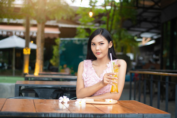 Beautiful woman face portrait with passionfruit  juice glass.