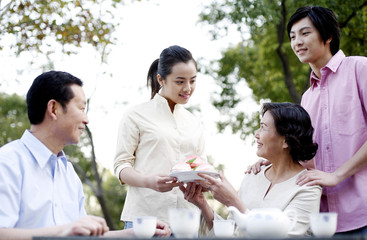 Woman receiving longevity peach from her daughter