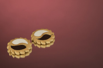 Cake with jam on a red mirror background