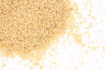 A pile of brown rice fills the upper left corner of the top on a white background with space for an inscription