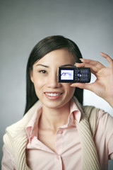 Businesswoman taking picture with her camera phone