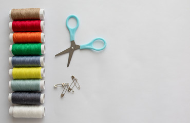 multi-colored thread scissors and pins