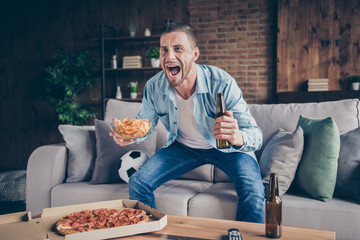 Photo of domestic handsome guy stay home quarantine time watch television eat pizza drink beer sit...
