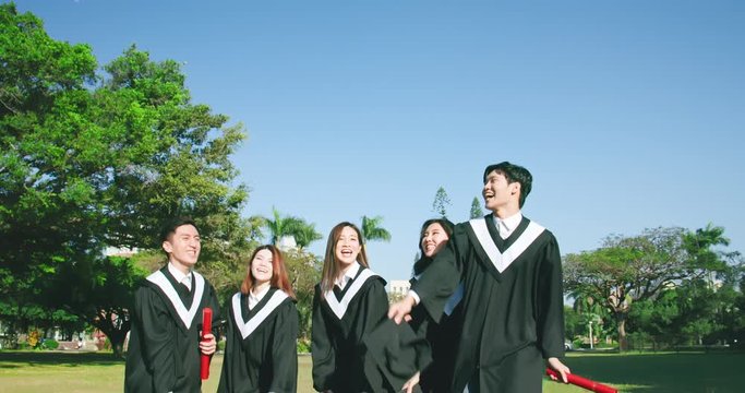 group happy graduates throw caps
