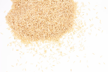 A pile of brown rice lies on a white background with space for an inscription.