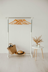 white hanger with wooden hangers on a white background