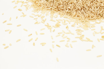 The upper right corner is filled with a pile of long-grain, brown rice placed on top on a white background with space for an inscription. The concept of background to describe the news.