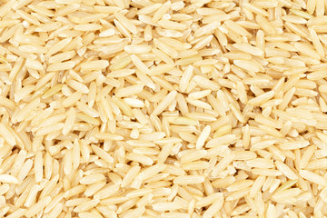 Texture of brown, long-grain rice close-up. Top view with space for the label.