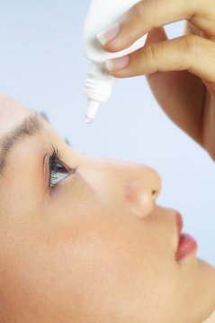 Close-up Side Shot Of Woman Dropping Some Eye Lubricant Into Her Eye