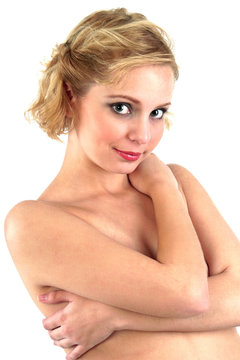 Studio shot of topless woman covering her breasts with her hands