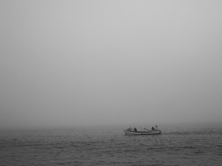 fisherman boat in the mist. Culatra Island, Algarve, Portugal.