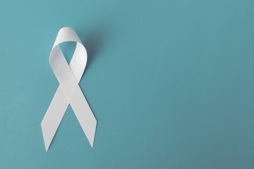 white ribbon on blue background, cancer awareness concept, hiv awareness concept, world AIDS day, world hypertension day