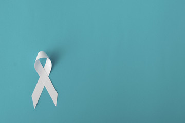 white ribbon on blue background, cancer awareness concept, hiv awareness concept, world AIDS day, world hypertension day