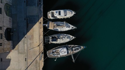 Aerial top down view of sailing boats moored in harbour Senglea (Isla), Bormla, Malta - island with old medieval architecture and culture. Water transport, nautical vessel.
