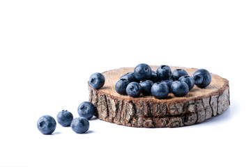 Freshly picked juicy blueberries on a wooden board. Blueberry antioxidant. Healthy eating concept. White background.