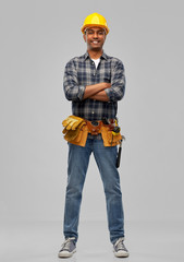 profession, construction and building - happy smiling indian worker or builder in helmet with crossed arms over grey background
