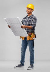 profession, construction and building - happy smiling indian builder in helmet with blueprint over grey background