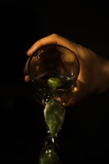 A man pours water with leaves. Water jet