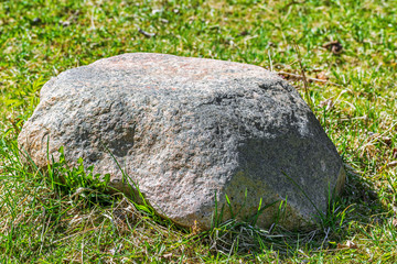 Stone in the grass.