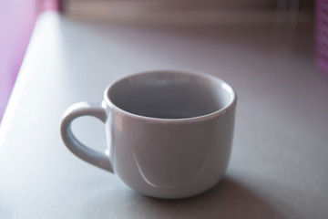 Empty gray ceramic mug on the table.