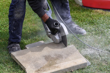 Industrial construction worker using a professional angle grinder