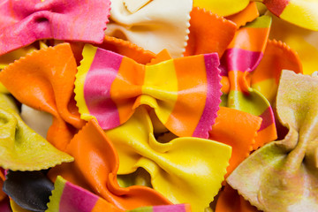Traditional handmade italian farfalle pastas close up colored background