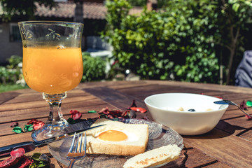 Beautiful and stylish breakfast on a wooden table on a garden