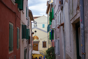 Fototapeta na wymiar Typical narrow alley with croatian houses in the picturesque old town of Rovinj, Croatia
