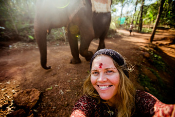 beautiful girl next to an elephant - 351182110