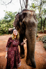 beautiful girl next to an elephant - 351182336