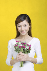 Woman holding a bouquet of flowers.