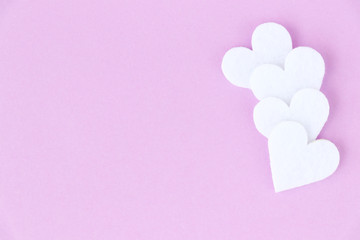 Love background. Decorative white fleece hearts on a light lilac background. Place for design.