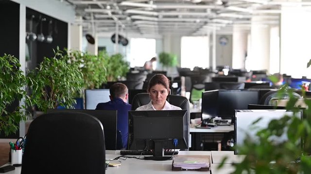 A woman freaks out and gets depressed from a mistake and breaks the keyboard on the monitor. Female manager gets angry and crashes a computer. Office clerk is stressed at work. Unstable psyche.