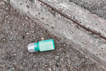 lost baby bottle with milk lies on the side of the road