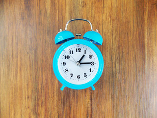 vintage alarm clock on wooden background