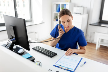medicine, technology and healthcare concept - female doctor or nurse with computer and clipboard...
