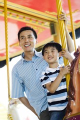 Father and son on a carousel