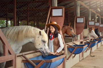 Cowgirl working stables.Concept of retro woman in horse ranch.vintage style