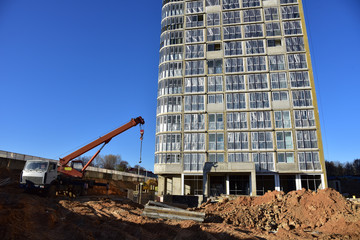 Mobile auto crane at construction site. Work of truck crane on project works
